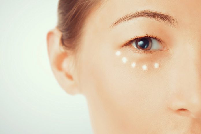 Portrait of woman with cream around the eye